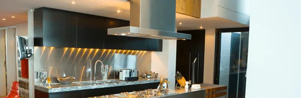 Modern kitchen with under-cabinet and range hood lighting